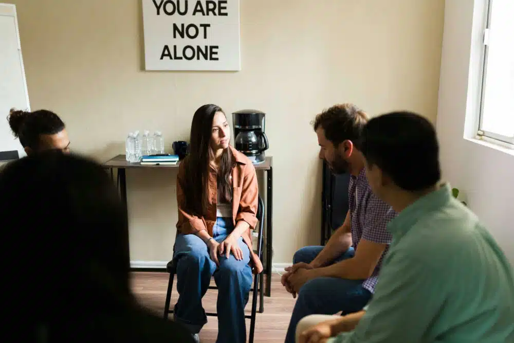 Group therapy session discussing relapse prevention strategies, providing support for individuals in recovery from addiction.