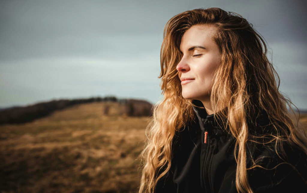 a-woman-with-eyes-closed-in-nature